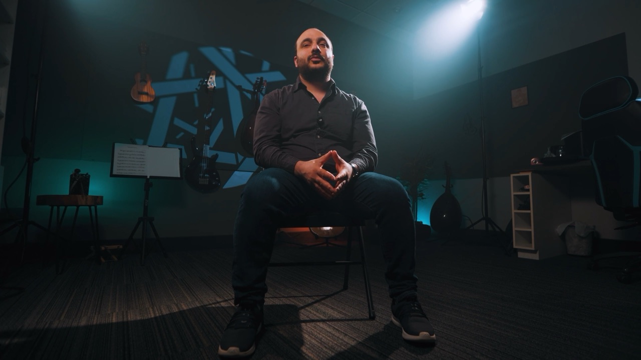 Gaby Al Botros seated under a spotlight in the film's interview set